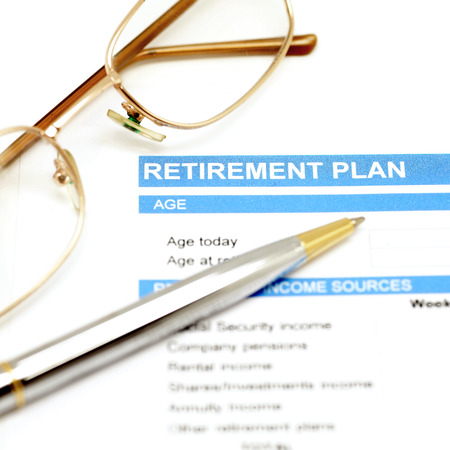 retirement plan document with pen and eye glassesの写真素材