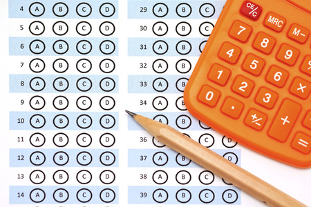 answer sheet test score with pencil and calculator