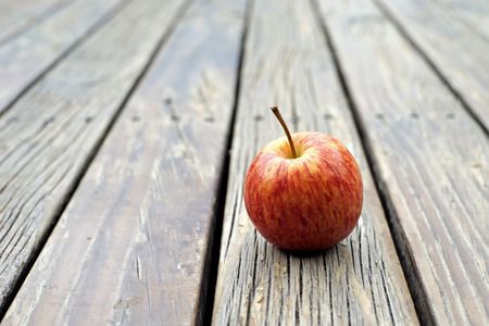sweet apple fruit on wooden floor backgroundの写真素材