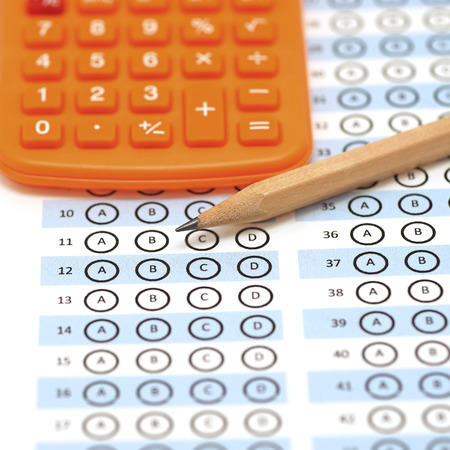 answer sheet test score with pencil and orange calculatorの写真素材