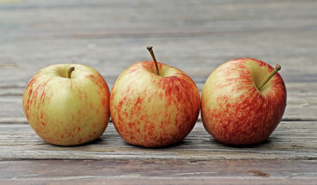 sweet apple fruit on wooden floor backgroundの写真素材