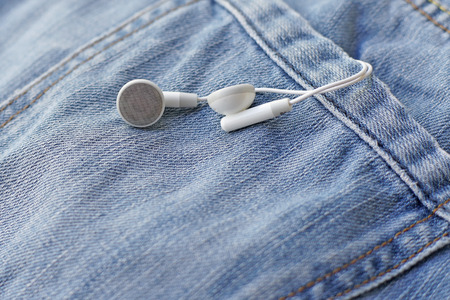 white earbuds in back pocket old jeansの写真素材