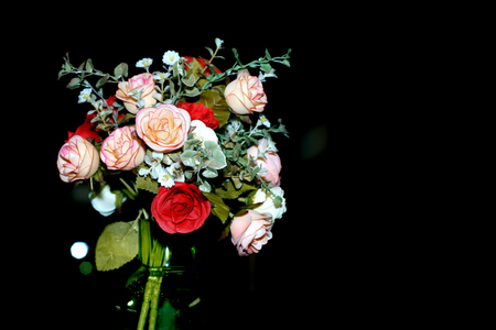 colorful of rose artificial flower in green vase on black backgroundの写真素材