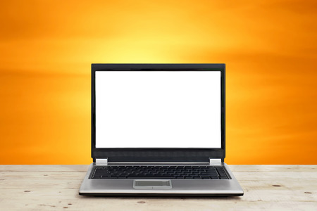 business concept idea, laptop with blank screen on wooden table with beautiful sunset background