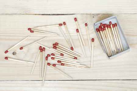 pile of matchstick and matchbox on wooden background