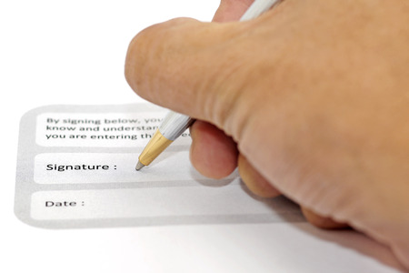 signature field on document with pen and human handの写真素材