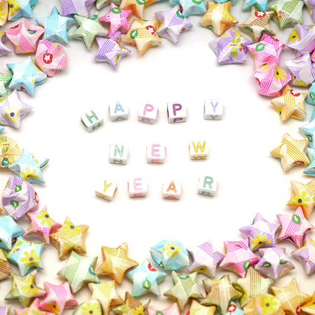 word happy new year  with origami lucky stars isolated on white background