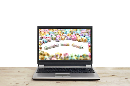 word happy new year on laptop screen  isolated on white backgroundの写真素材