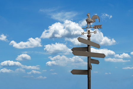 direction sign with blank spaces for text on beautiful sky backgroundの写真素材