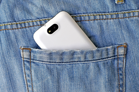mobile smart phone in back pocket blue jeansの写真素材