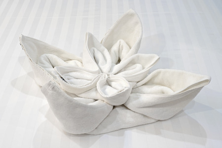 lotus flower shaped of towel on the bedの写真素材