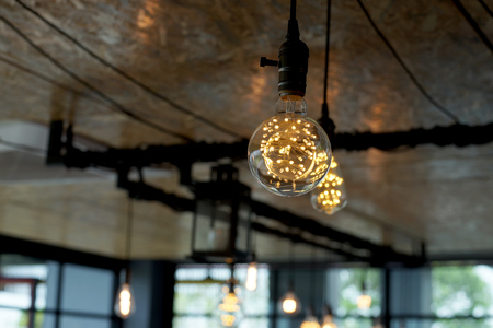 decorative antique tungsten light bulbs hanging on ceilingの写真素材