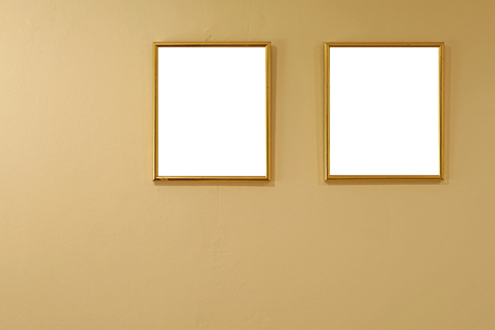 empty golden picture frames on the cement wallの写真素材