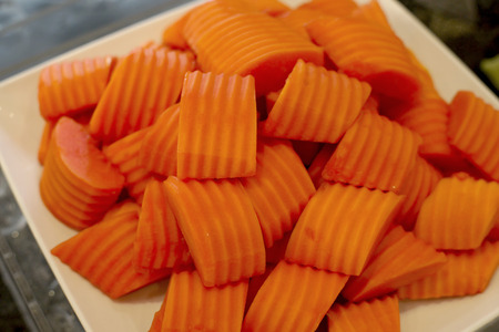 peel papaya in white plate on buffet lineの写真素材