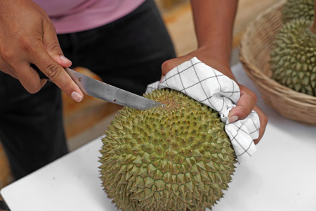 vendor peeling durian for customer in fruit market