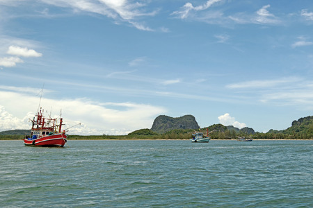 landscape view of ocean with fishing boat and beautiful sky background