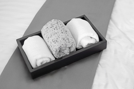 bath towels  in black tray on bedの写真素材