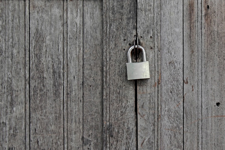 old rusty padlocked on vintage wooden doorの写真素材
