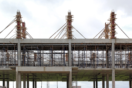 new building under construction with brick work and wooden scaffolding