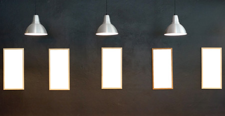 gallery interior, empty picture frames on the wall with lighting