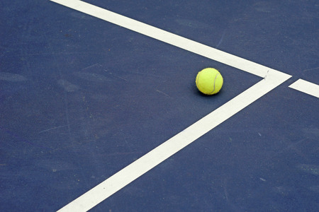 tennis ball at the corner of courtの写真素材