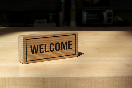 welcome sign on counter bar in coffee shopの写真素材