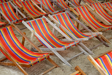 pile of relaxation sunbathing chairs on beachの写真素材