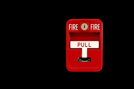 red fire alarm box on black background