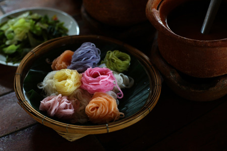 famous thai food kanom jeen, colorful thai noodle with curry and vegetablesの写真素材