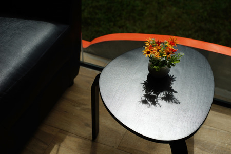 artificial flower in flowerpot decorated on table in coffee shopの写真素材