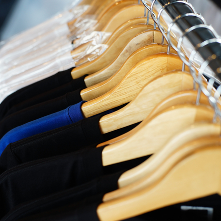 image shirts hanging on hanger in boutique