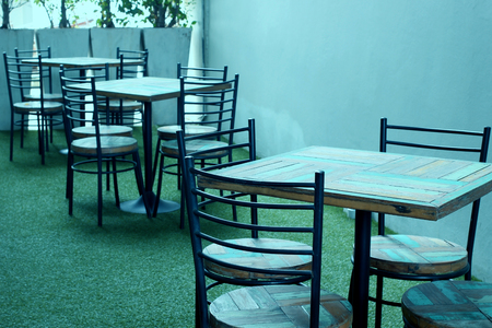 empty wooden and chair set on patio of restaurantの写真素材