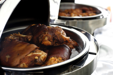 stewed pork leg in steam pans on buffet tableの写真素材