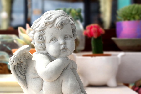 statue of an cute infant angel (cupid)