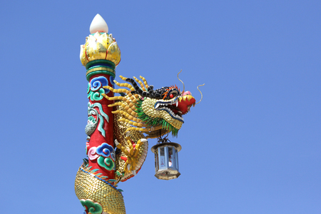 chinese dragon on post in the shrine with beautiful sky backgroundの写真素材