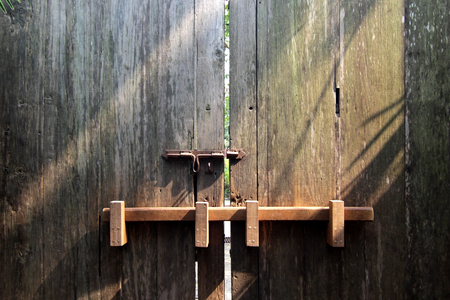 closeup image of ancient wooden doors in countrysideの写真素材
