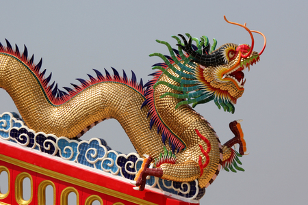 Golden dragon in Chinese temple with beautiful sky backgroundの写真素材