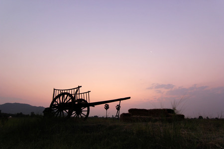 silhouette of bullock cart in field with sunrise backgroundの写真素材