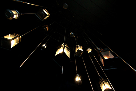 pile of vintage lamp hanging on ceiling with turn on  light bulb