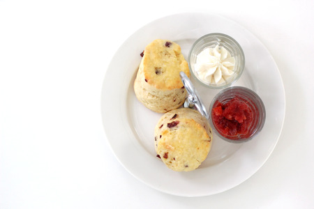 little cake with cream and strawberry jam on white tableの写真素材