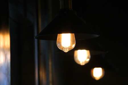 decorative lamp with turn on  light bulb hanging on ceilingの写真素材