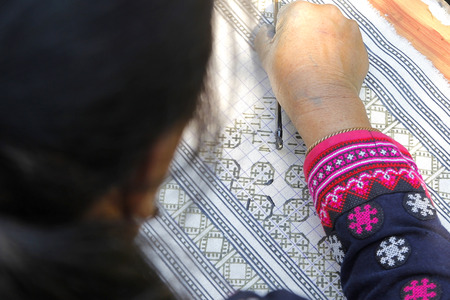 closeup of hmong hilltribe writing candles to made traditional clothsの写真素材