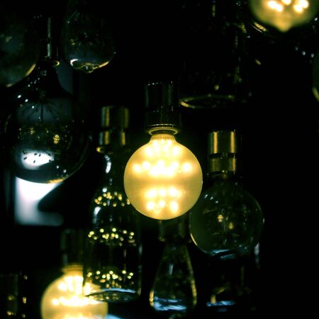 pile of LED light bulbs are decorated on the ceilingの写真素材