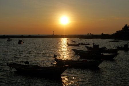 fishing boat in the sea with sunset backgroundの写真素材