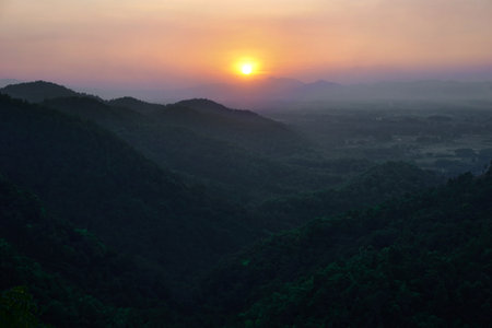 landscape view of sunset over the green mountainsの写真素材
