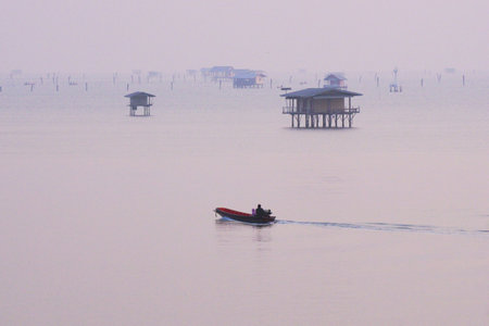 Small boats in the sea with hut of fishermen backgroundの写真素材