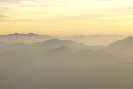 landscape photo, misty mountain hills in the morningの写真素材