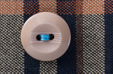 button on brown cloth in macroの写真素材