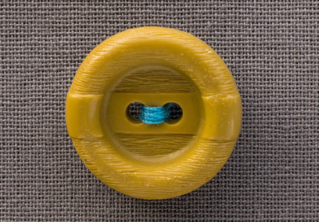 button on gray fabric in macroの写真素材