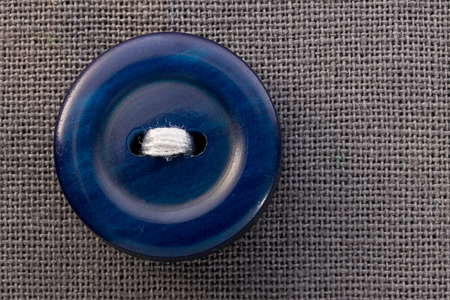 button on gray fabric in macroの写真素材